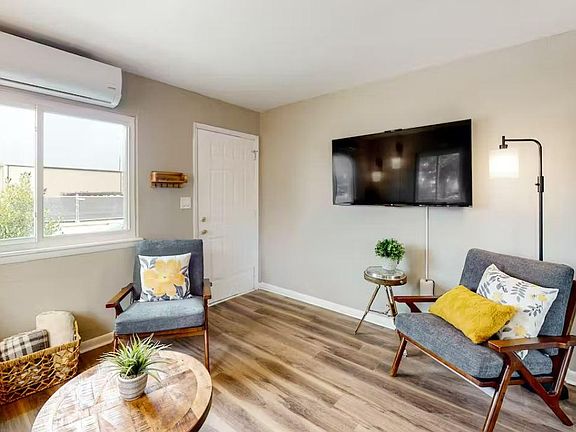 Oversized Smart TV in living room. Second Smart TV in bedroom