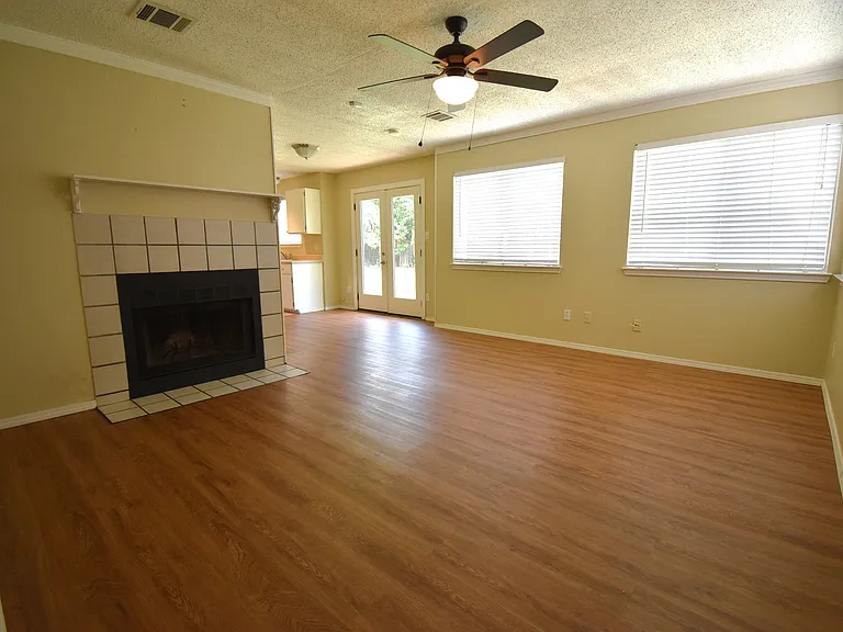 Living room with large windows and a cozy fireplace