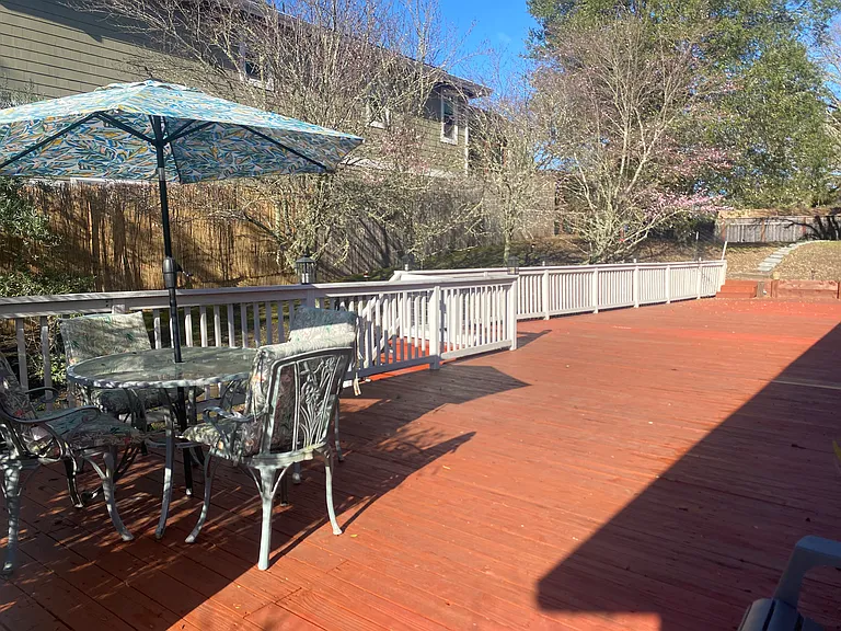 1,500_SF Wraparound Redwood Deck Featuring Wrought_Iron Antique Glass Table and Chairs