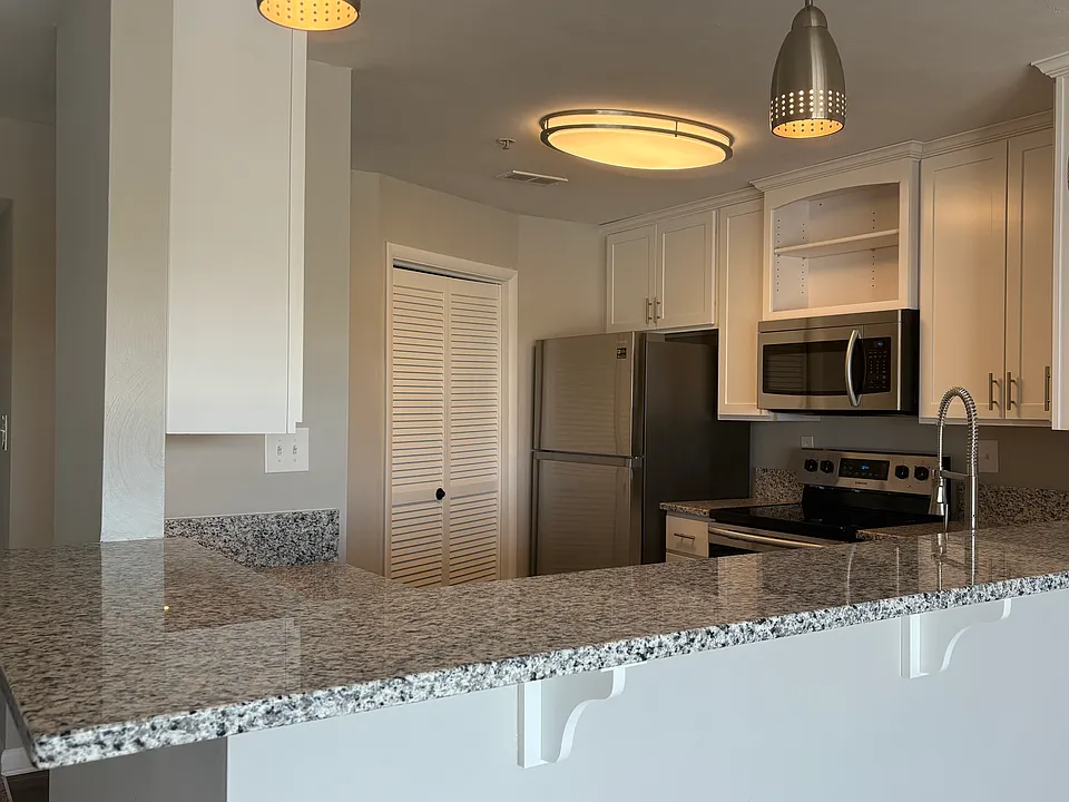 Open kitchen with wrap around breakfast bar