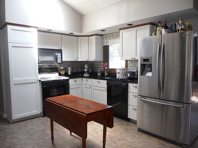 Updated Kitchen with granite coounter tops, vaulted ceiling and skylights