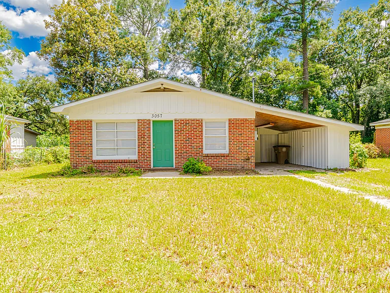 Front of home with covered carport. Laundry under carport