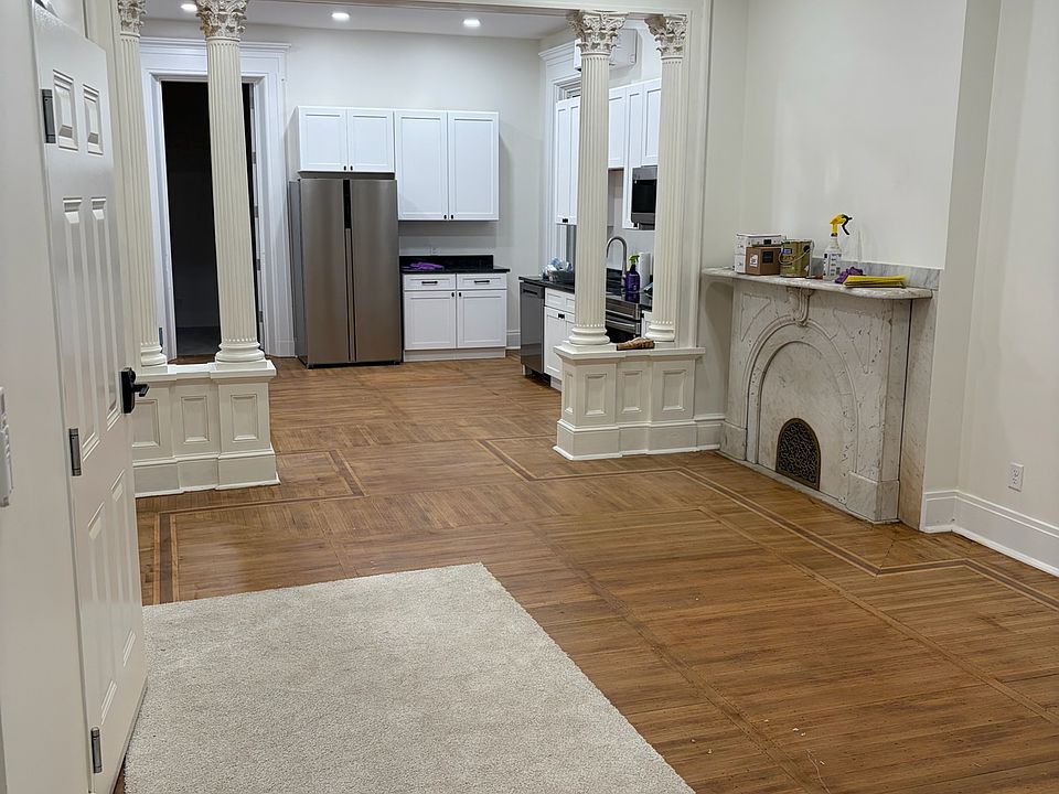 Large living area and kitchen area complimented with architectural details of bygone era.