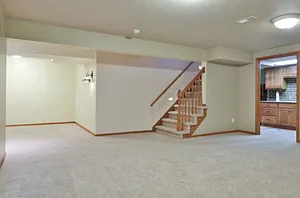 Basement family room, with small kitchenette for entertaining.