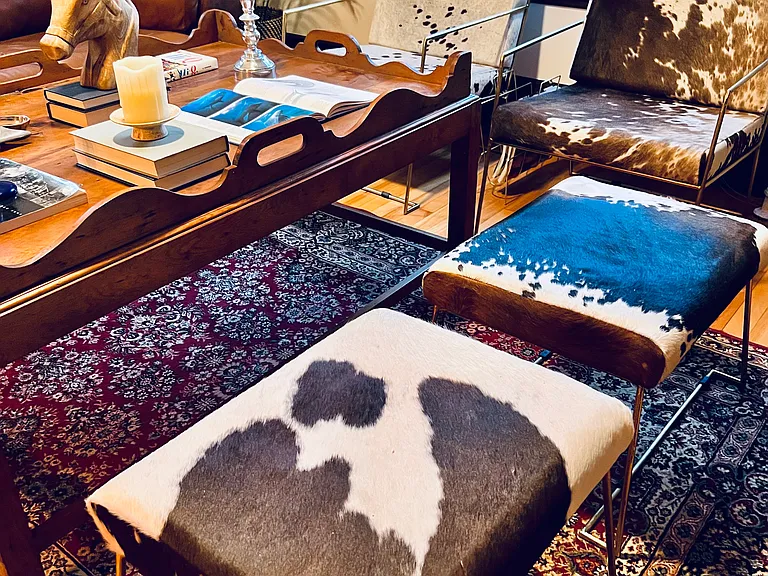Cow hide accent pieces and chairs.