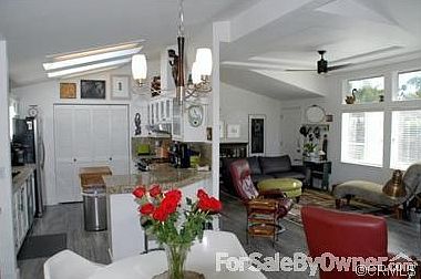 Spacious and airy great room
						:
						New wood floor, vaulted ceilings with fan and skylights enhance casual living.