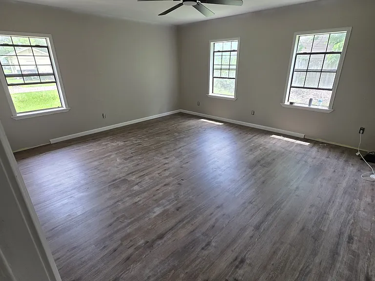4th bedroom on back of house added during renovations. Updated flooring and ceiling fan, large walk in closet.