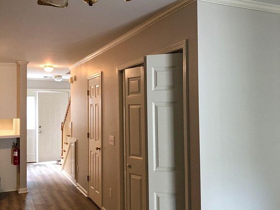 Hall from Living Room to Front Door. Laundry on right. New LVP flooring. Painting walls, trim, doors and ceilings.