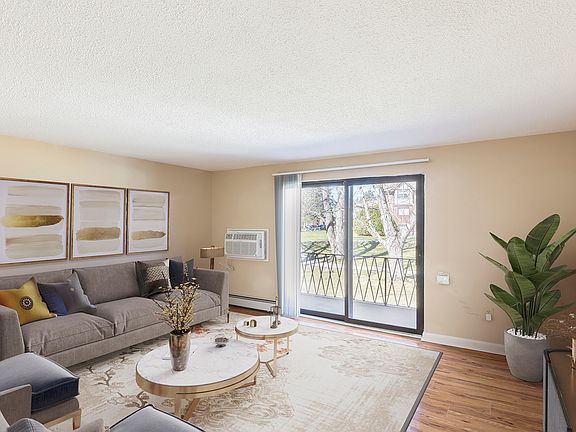 Spacious living room with balcony access and wood flooring