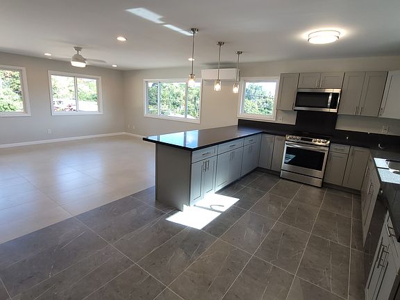 Upstairs kitchen, tile flooring , polished granite counter tops, wood cabinets, split ac, hanging tea lights, under counter seating, dual s/s kitchen sink, dishwasher, walk-in kitchen pantry