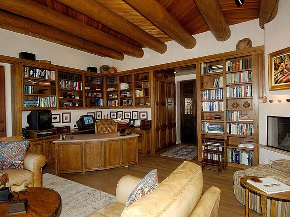 Its all about wood! Wooden floor, builtin bk shelves, custom wd entertainm.