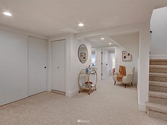 Doors lead to hall closet, kitchen/laundry with new appliances, floor, shelves, etc., and to the two bedrooms.