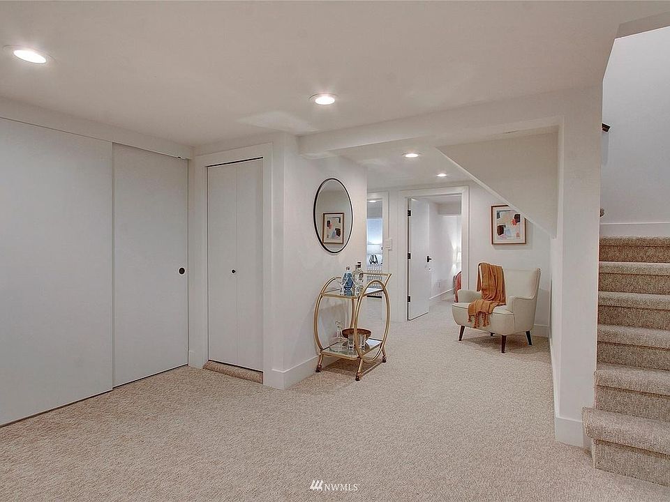 Doors lead to hall closet, kitchen/laundry with new appliances, floor, shelves, etc., and to the two bedrooms.