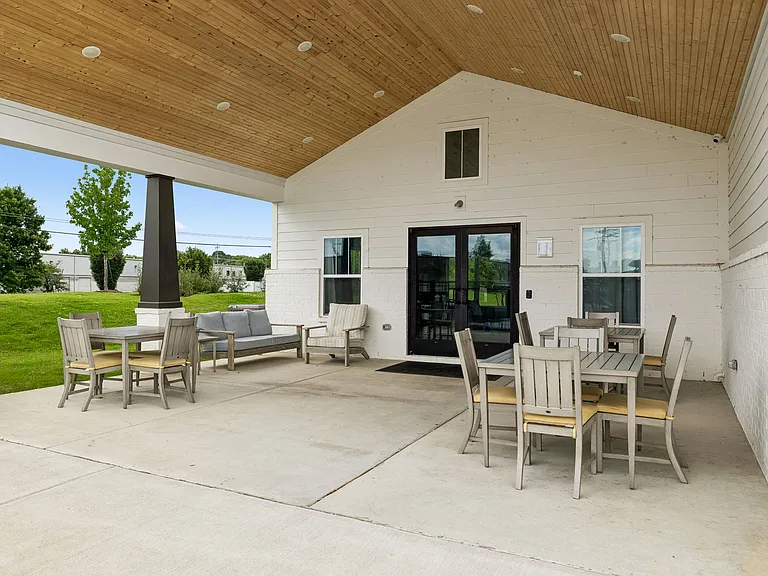 Outdoor community patio with seating and gathering space, ideal for entertaining, socializing, or enjoying the outdoors.