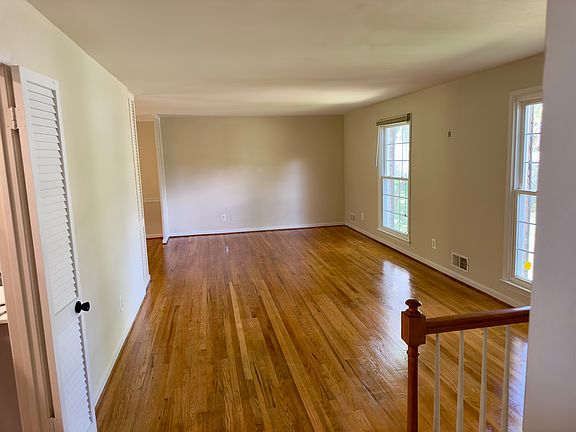Living room with windows overlooking front yard