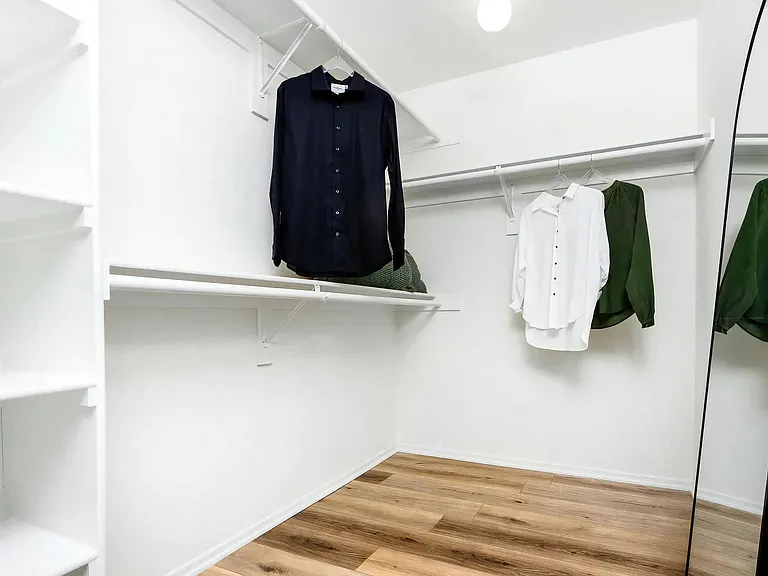 Spacious Walk-In Closet with Hanging Rods and Open Shelving