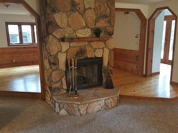 Stone fireplace between fam/dining room