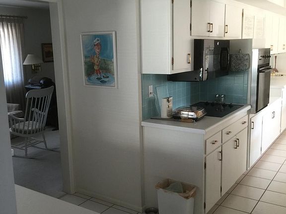 Kitchen on the right, living room entry on the left