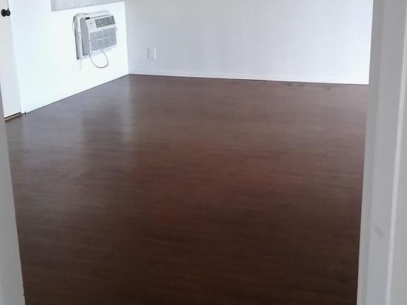 Living room with AC unit, hardwood floors
