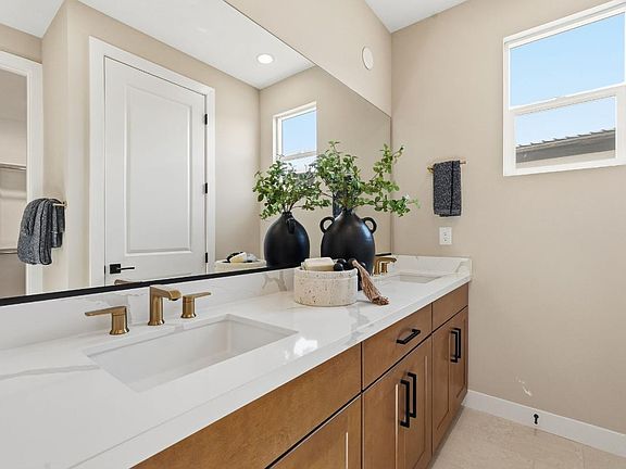 Serene primary bathroom with glass shower door and dual-sink vanity