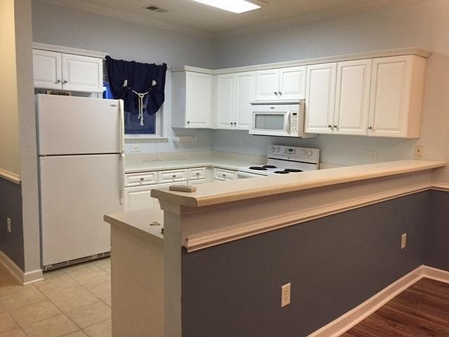 Larger galley kitchen with breakfast bar