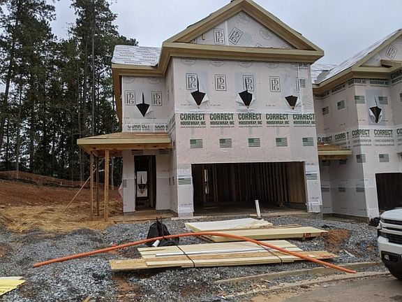 UNDER CONSTRUCTION. Great end unit with wrap front porch, sitting next to a protected tree save are