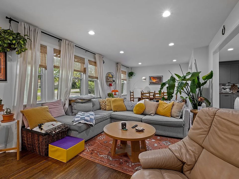 Another view of living room. Dont miss the chic blinds on the windows!