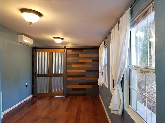 Master bedroom. This picture does not do this room justice! There are 4 windows overlooking the lovely back yard and this room is large enough for a king sized bed. The far wall has a barn door that slides open to the huge walk in closet