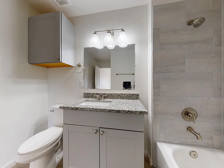 ceramic tile surround with shower of tub in one master bath