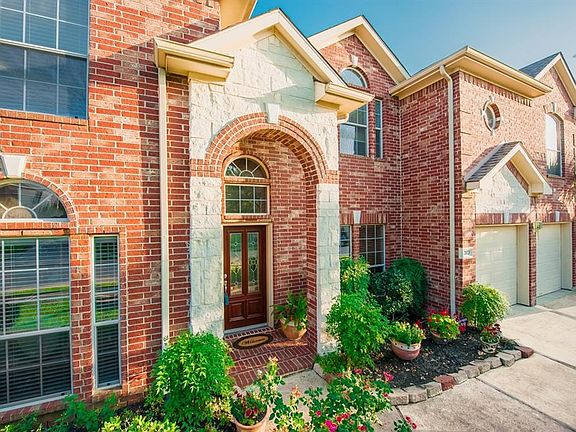 Front door faces east. The front of the house is gorgeous! Notice the perfect combination of brick and stone with the little added architectural designs and details.