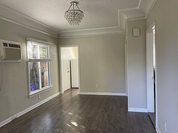 Living room facing dining area to kitchen