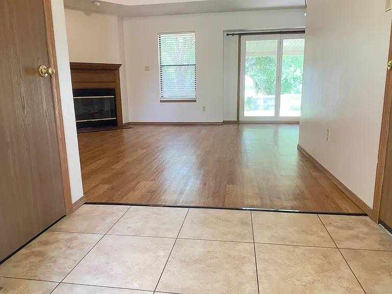 Spacious Entry into Home with Coat Closet to the left and door leading to Garage on right.