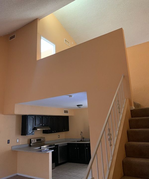 Experience a seamless flow between the kitchen, staircase, and living room in this thoughtfully designed space. The kitchen opens directly into the living area, fostering an open and welcoming atmosphere perfect for everyday living or entertaining.
