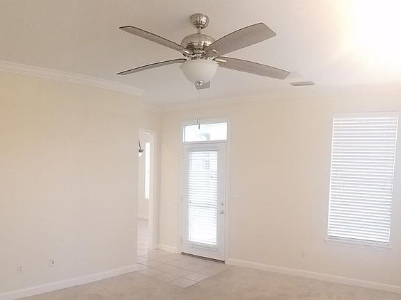 Living room with new ceiling fan--lots of natural light
