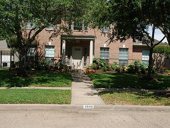 Mature trees and colorful landscaping accent the front of your home.