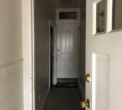 Entrance hallway from front door. Entrance to apartment is on left. Entrance straight ahead is to the 2nd floor apt.