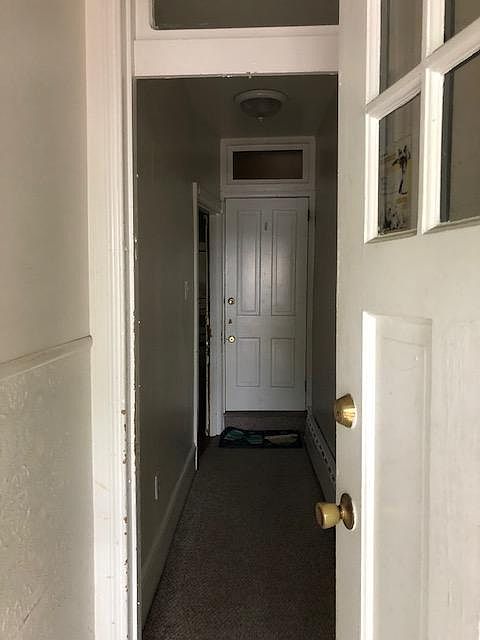 Entrance hallway from front door. Entrance to apartment is on left. Entrance straight ahead is to the 2nd floor apt.