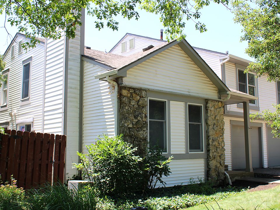 Exterior view: the enclosed fenced patio is to the left and the one vehicle garage is to the right