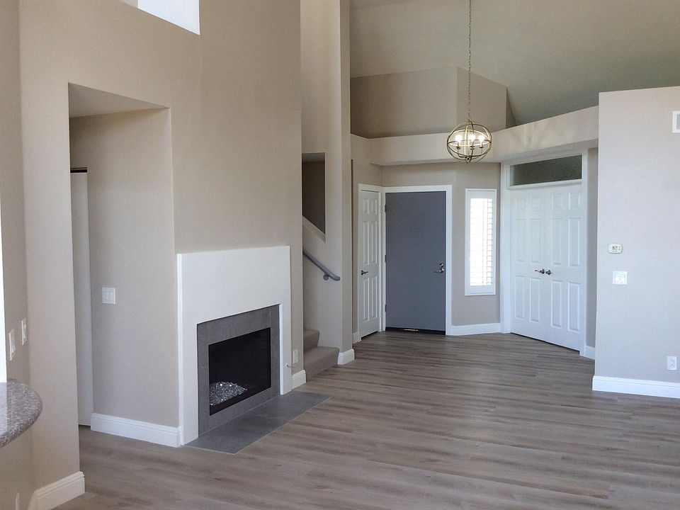 Double doors to the right of the entry lead to a smaller bedroom/office with attached 1/2 bath