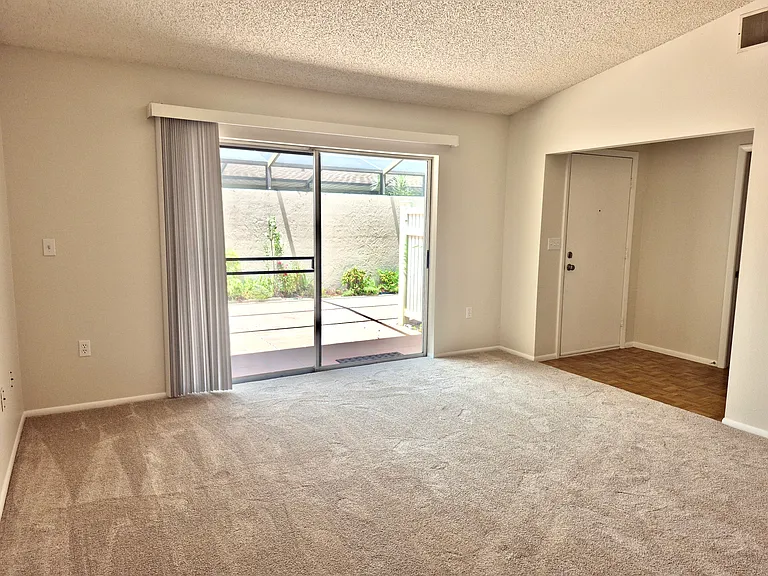 Lounge view of entrance hall. Split level layout for privacy with a closing slide door by front door.