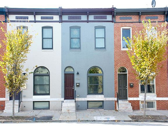 Gray with maroon door, marble steps.
