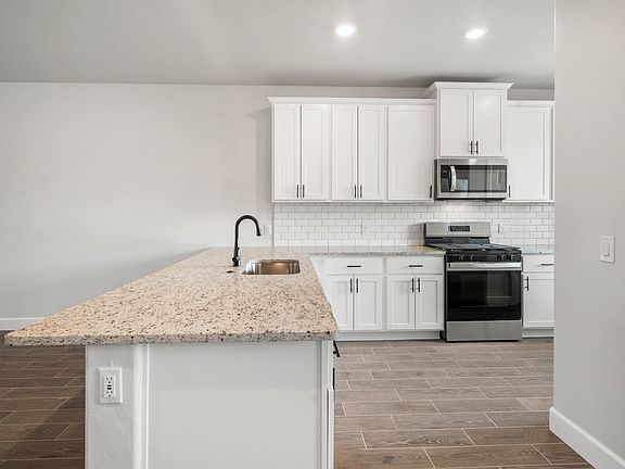 The kitchen has sprawling granite countertops.