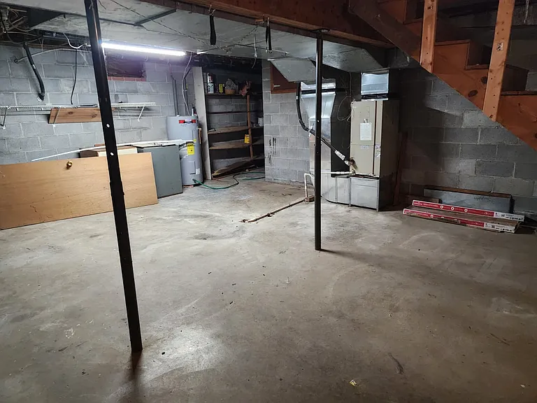 Partial basement, air handler, water heater, storage space.