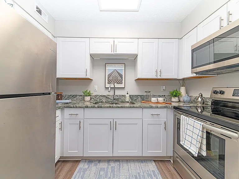 Kitchen with granite counters, stainless appliances, and modern cabinetry