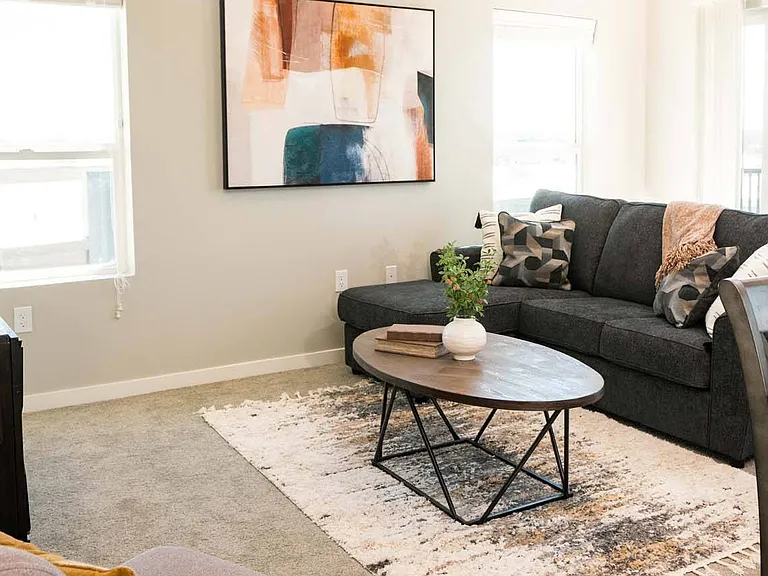 Chair and couch in a living room at Heartland Flats Alliance.