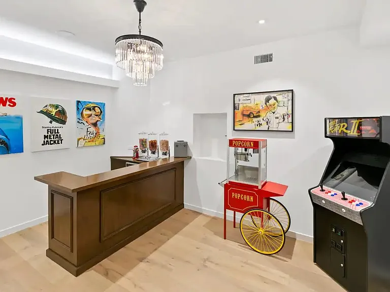 Entertainment room with arcade game, popcorn maker, candy machines, and an extra flare of fun pop-culture artwork.