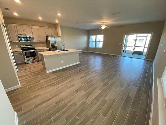 Open concept layout: dining & living room areas connected to kitchen