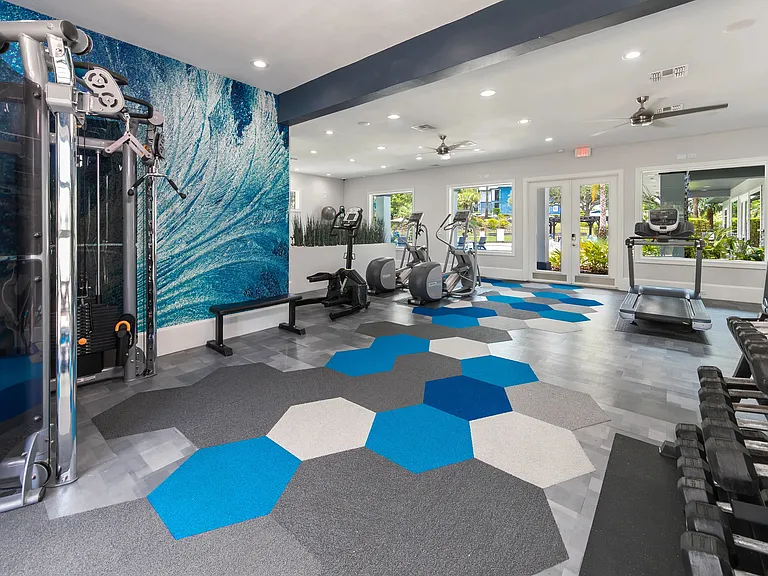 The fitness center at Elevate 155 features premium cardio machines, free weights, and strength equipment in a vibrant, contemporary space.