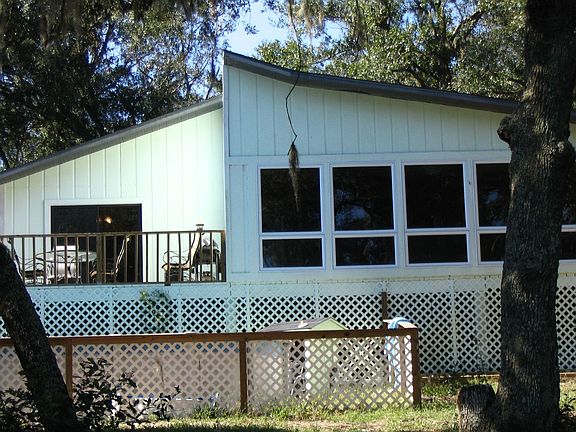 View of Sunroom with decks and pool