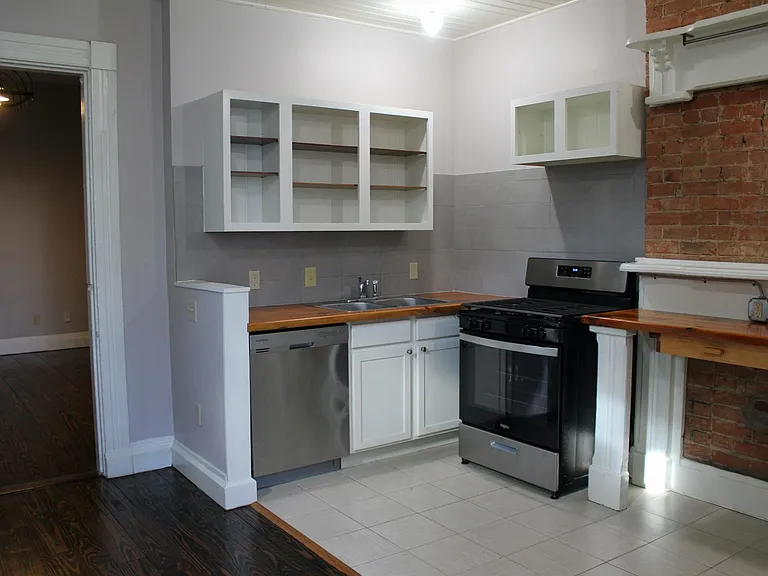 Large kitchen, stainless steel appliances, new stove.